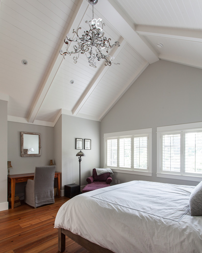 Example of a mid-sized classic master medium tone wood floor and brown floor bedroom design in Vancouver with gray walls
