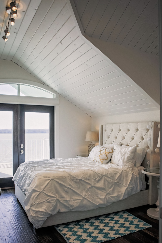 Imagen de dormitorio principal marinero grande sin chimenea con paredes blancas, suelo de madera oscura y suelo marrón