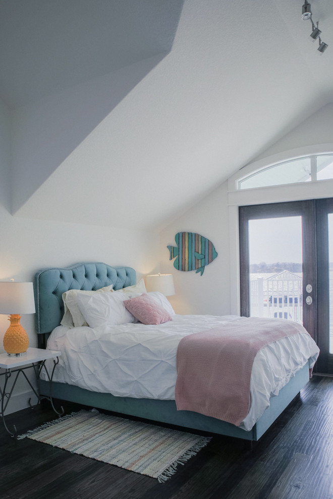 ダラスにある広いビーチスタイルのおしゃれな客用寝室 (白い壁、濃色無垢フローリング、暖炉なし、茶色い床) のインテリア