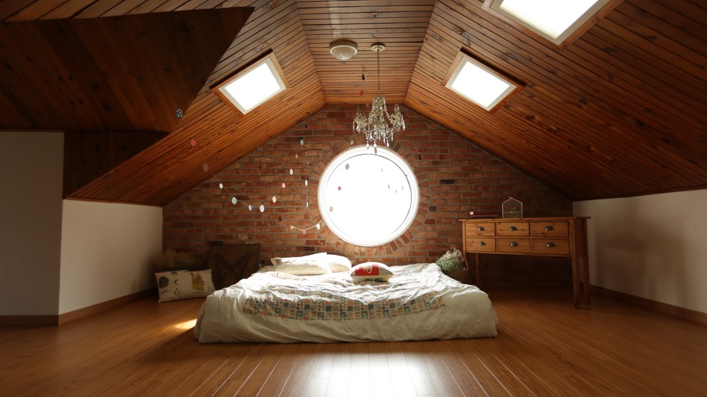 Example of a transitional medium tone wood floor and orange floor bedroom design in Melbourne with white walls