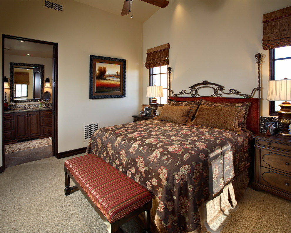 Photo of a mediterranean bedroom in Phoenix with beige walls and carpet.