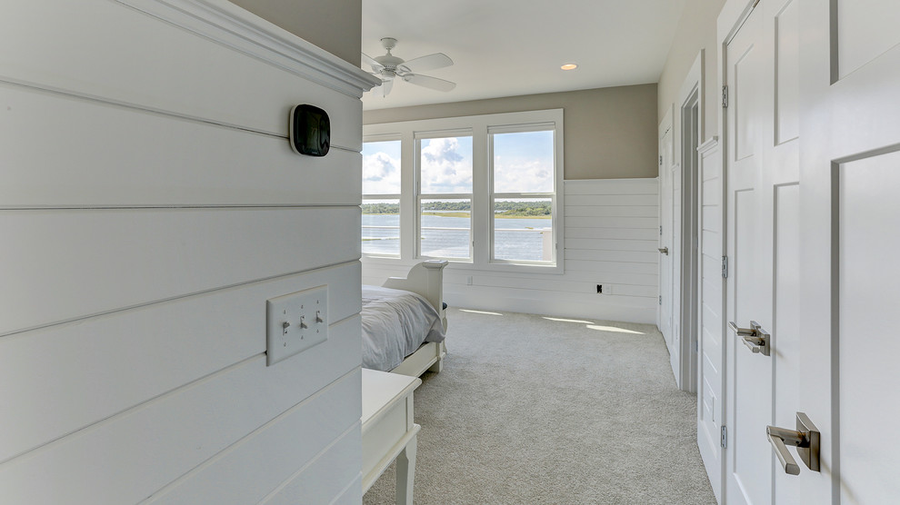 Foto på ett maritimt sovrum, med grå väggar, heltäckningsmatta och beiget golv