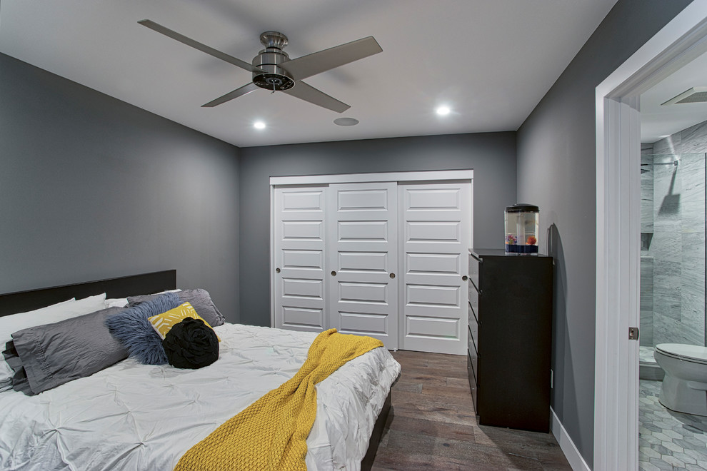 Photo of a large contemporary guest bedroom in Phoenix with grey walls, medium hardwood flooring, no fireplace and brown floors.