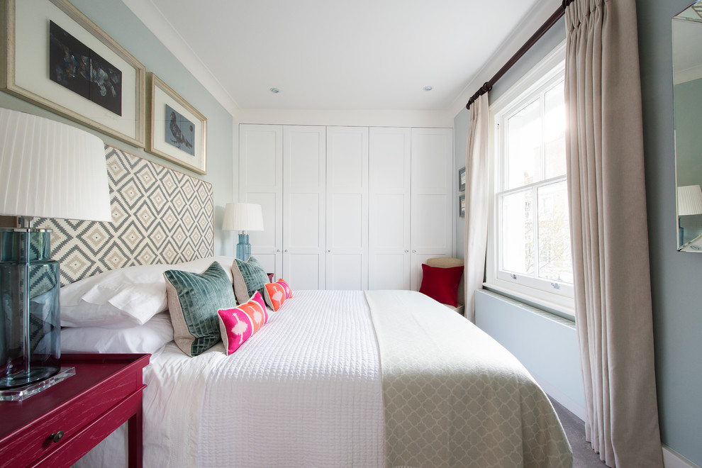 Inspiration for a medium sized traditional bedroom in London with blue walls.