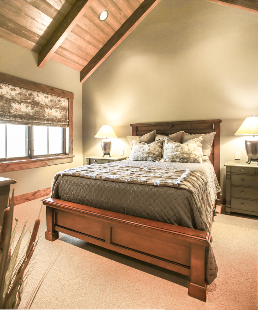 Inspiration for a large rustic guest bedroom in Other with beige walls and carpet.