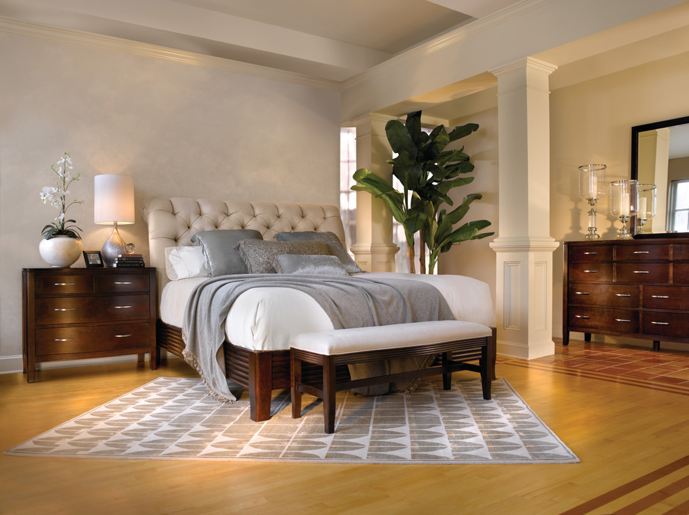 Example of a large transitional master medium tone wood floor and brown floor bedroom design in Chicago with beige walls and no fireplace