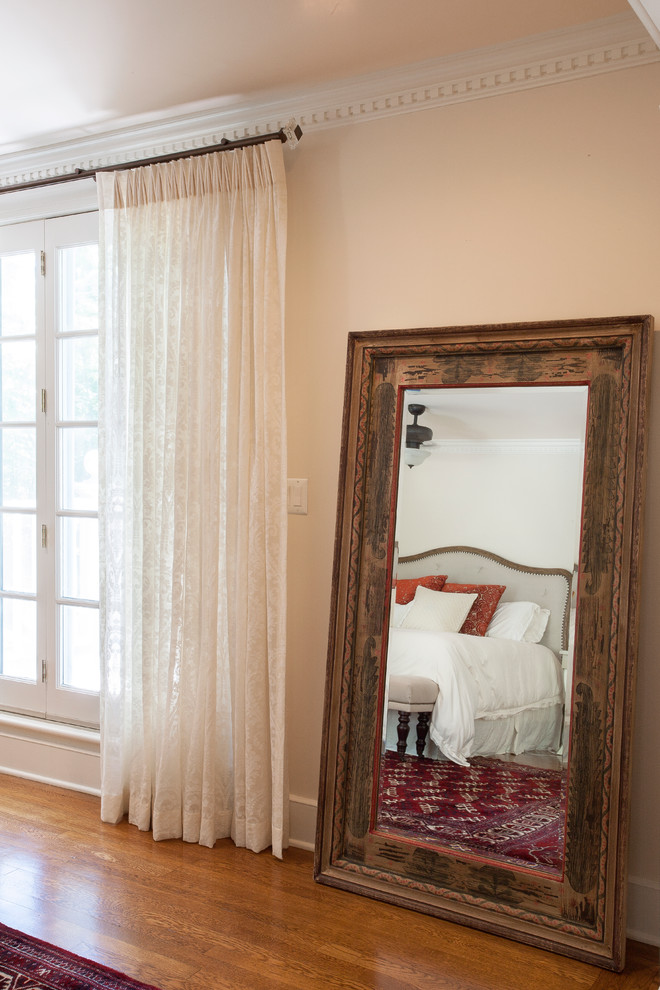 Photo of a large traditional master bedroom in Philadelphia with white walls, medium hardwood flooring and brown floors.