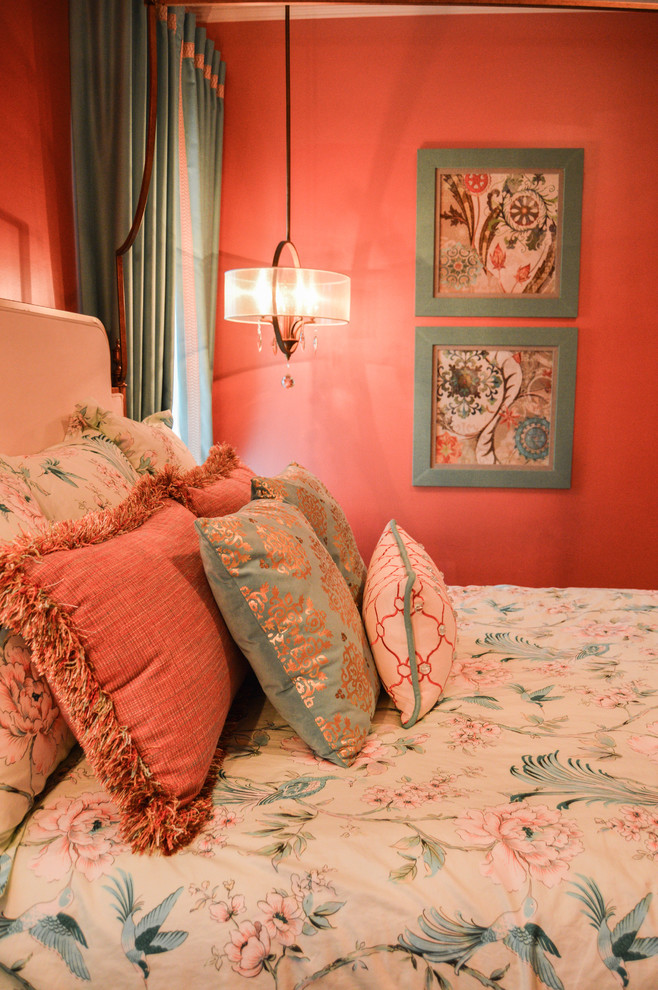 This is an example of a large traditional guest bedroom in New Orleans with pink walls, dark hardwood flooring and no fireplace.