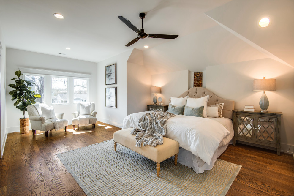 Photo of a classic master bedroom in Nashville with white walls, medium hardwood flooring, no fireplace and brown floors.