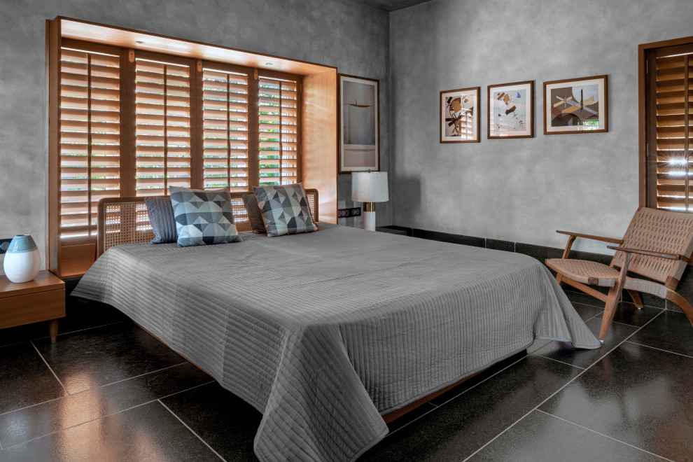 Inspiration för moderna sovrum, med grå väggar och svart golv