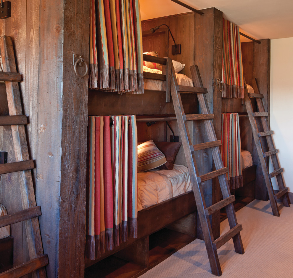This is an example of a medium sized rustic bedroom in Denver with beige walls and carpet.
