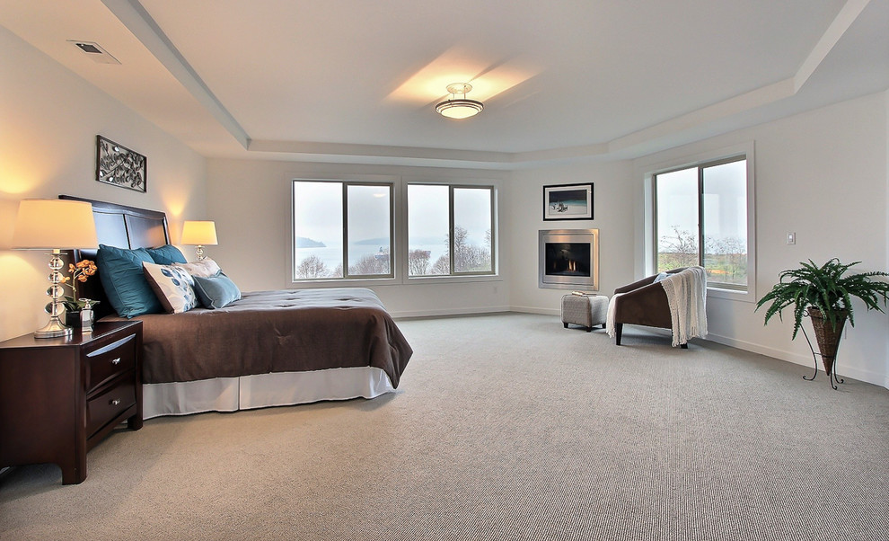 Inspiration for a large transitional master carpeted bedroom remodel in Seattle with white walls, a corner fireplace and a metal fireplace