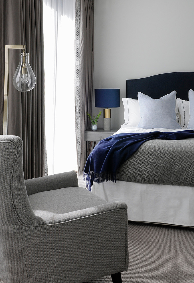 Example of a mid-sized transitional carpeted bedroom design in London with gray walls, a corner fireplace and a brick fireplace