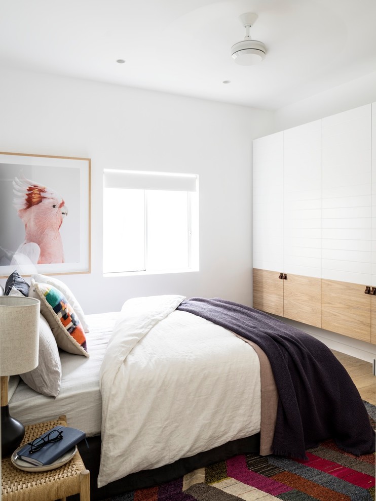 Example of a small beach style bedroom design in Sydney with white walls