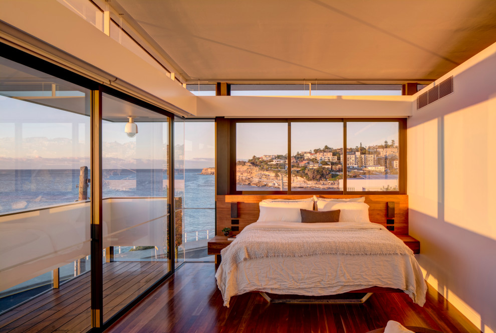 Photo of a contemporary master bedroom in Sydney with medium hardwood flooring.