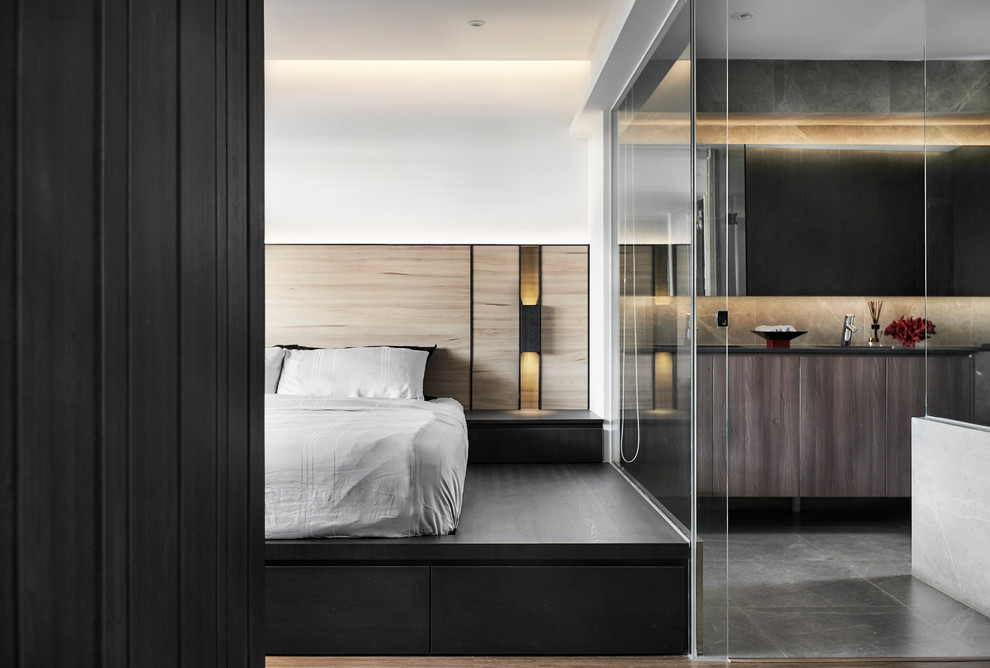 Example of a trendy master medium tone wood floor and brown floor bedroom design in Singapore with white walls