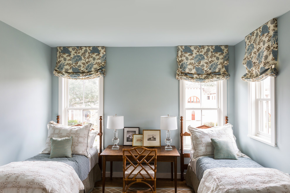 Example of a classic medium tone wood floor and brown floor bedroom design in Houston with blue walls