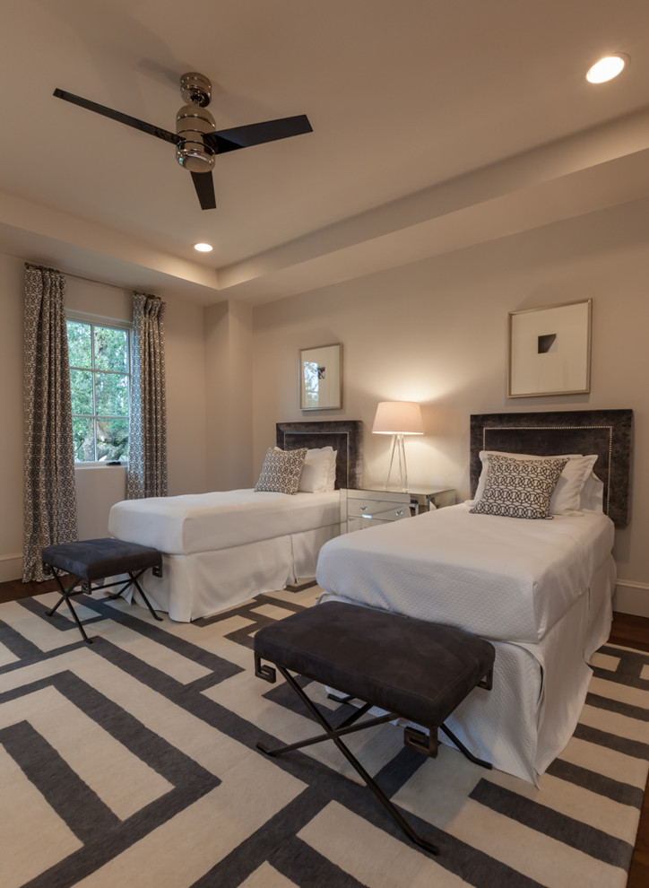 Photo of a large classic guest bedroom in Houston with beige walls and dark hardwood flooring.