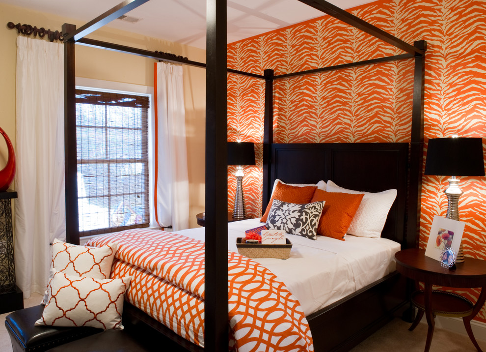 This is an example of a medium sized traditional guest bedroom in DC Metro with orange walls and carpet.
