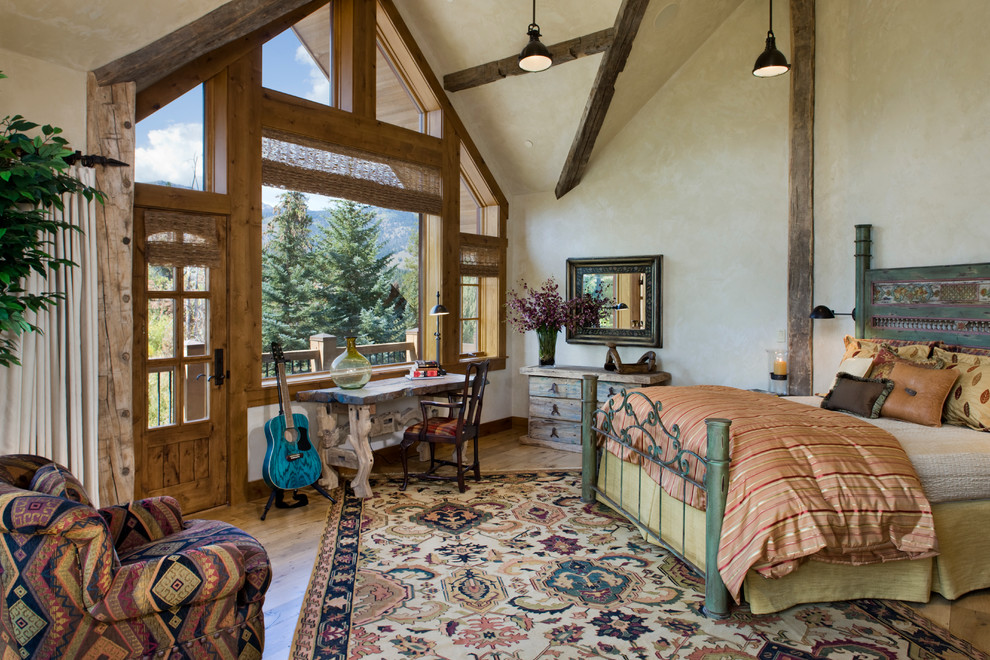 Mountain style medium tone wood floor bedroom photo in Other with beige walls