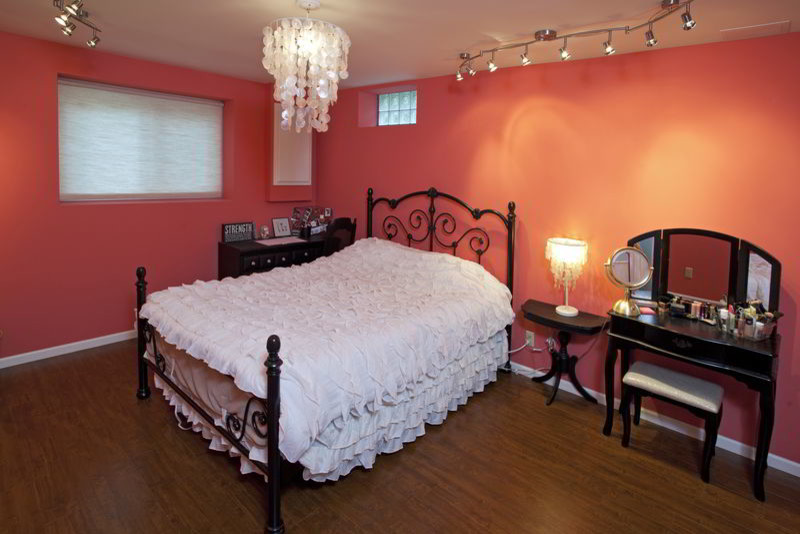 Example of a trendy bedroom design in Milwaukee with orange walls
