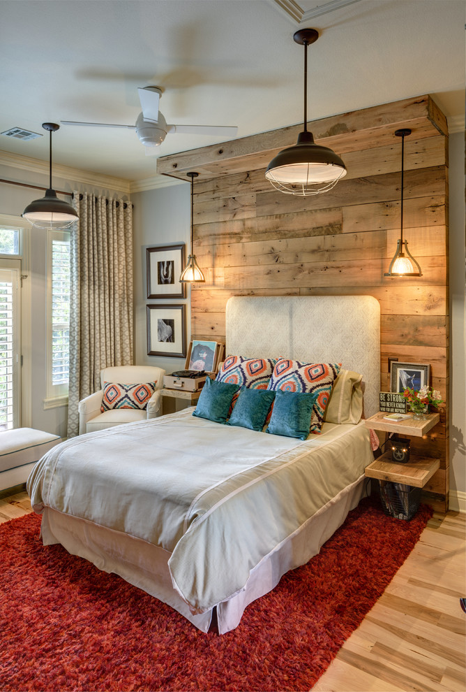 Medium sized farmhouse bedroom in Other with grey walls and medium hardwood flooring.