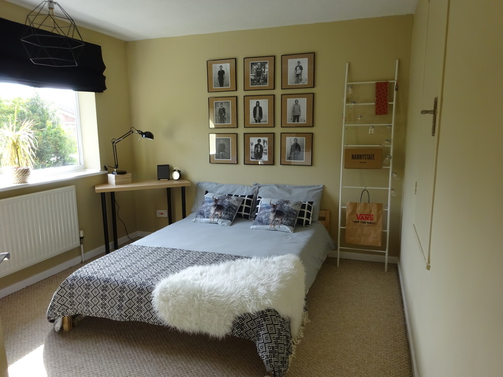 This is an example of a large scandinavian master bedroom in West Midlands with beige walls, carpet and beige floors.