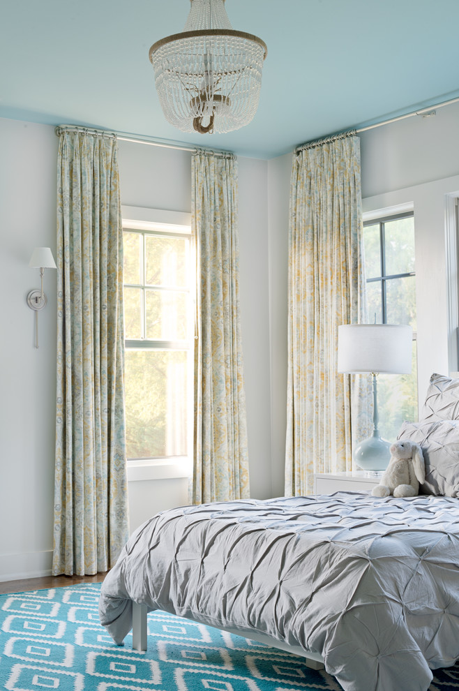 Example of a mid-sized transitional master medium tone wood floor and brown floor bedroom design in Other with white walls