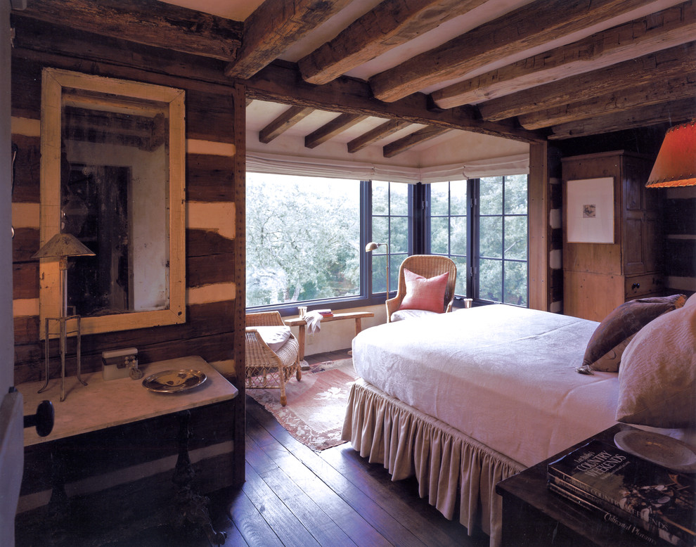 This is an example of a rustic bedroom in Austin with dark hardwood flooring.