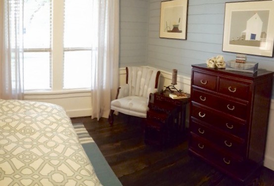 Foto på ett mellanstort vintage sovrum, med blå väggar och mörkt trägolv