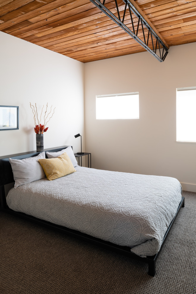Design ideas for a medium sized urban guest bedroom in Denver with beige walls, carpet, no fireplace and grey floors.
