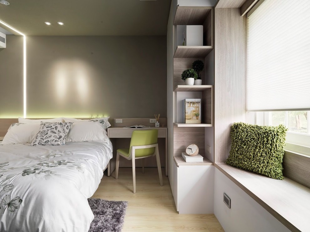Modelo de dormitorio principal contemporáneo de tamaño medio con paredes verdes y suelo de contrachapado