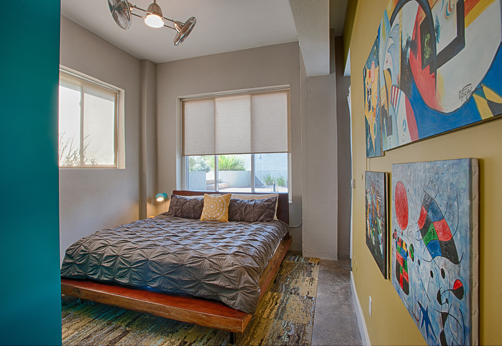 Photo of an industrial bedroom in Austin with concrete flooring.