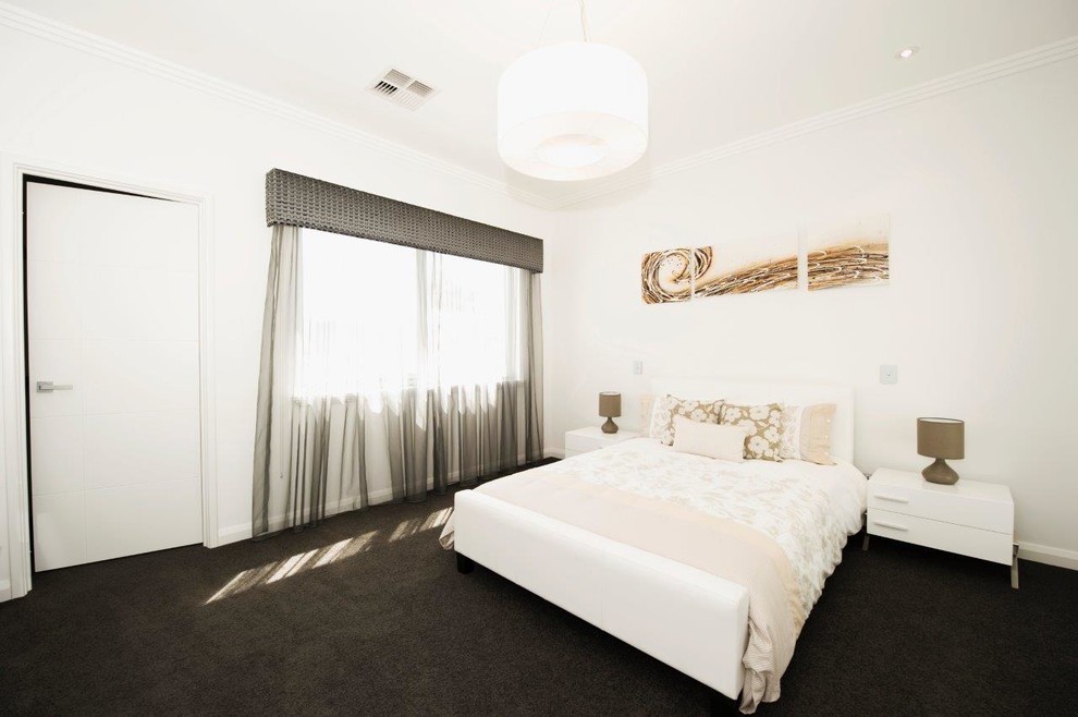 Ispirazione per una grande camera degli ospiti minimalista con pareti beige, moquette e pavimento grigio