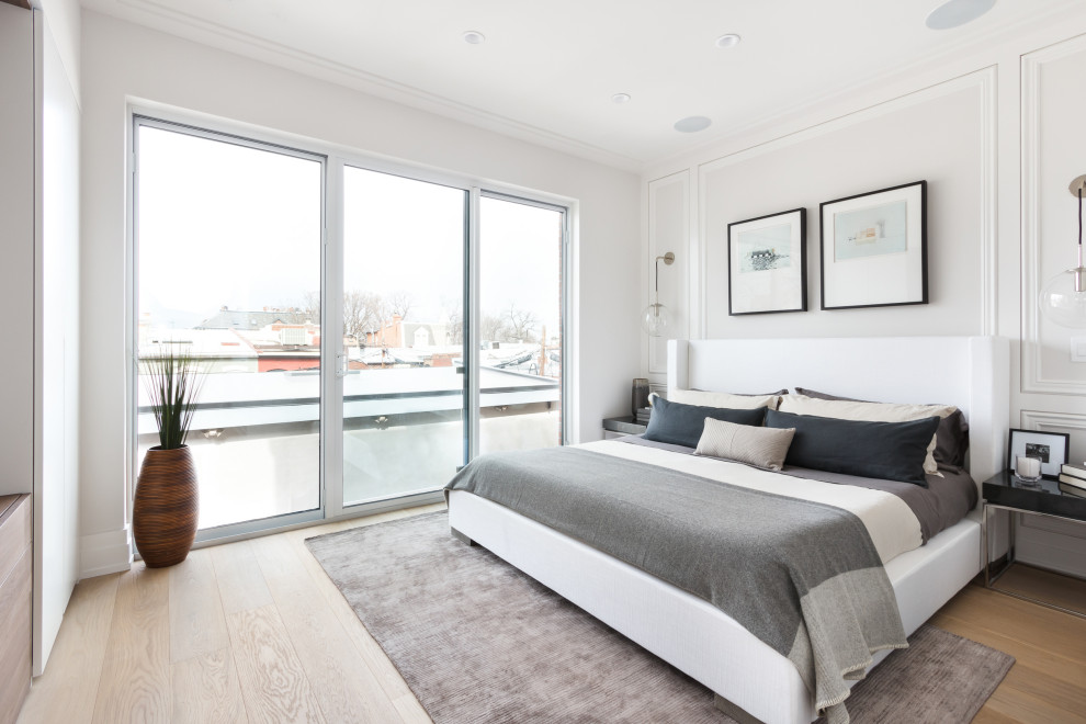 Foto de dormitorio principal escandinavo grande con paredes blancas, suelo de madera clara, suelo beige y panelado