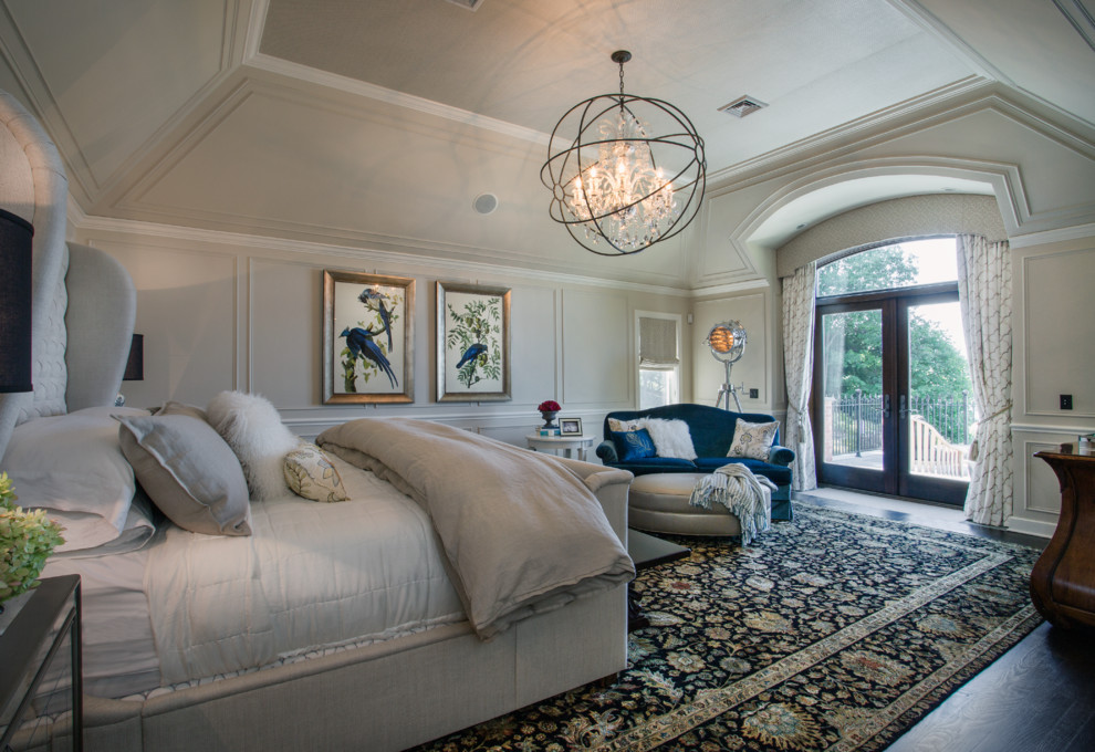 Large traditional master bedroom in New York with beige walls, dark hardwood flooring and no fireplace.