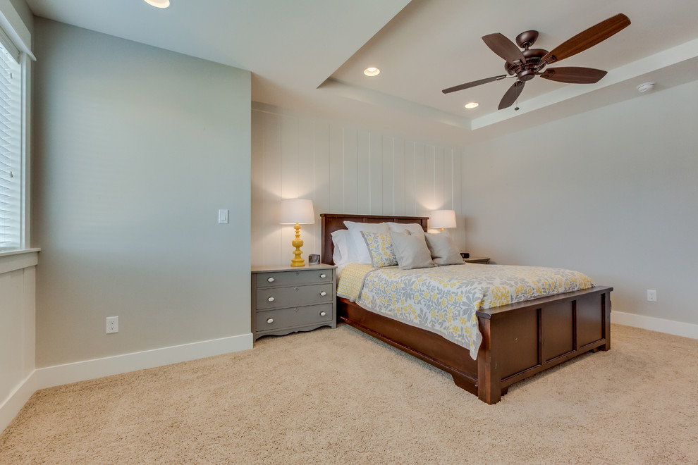 This is an example of a large traditional master bedroom in Boise with beige walls and carpet.