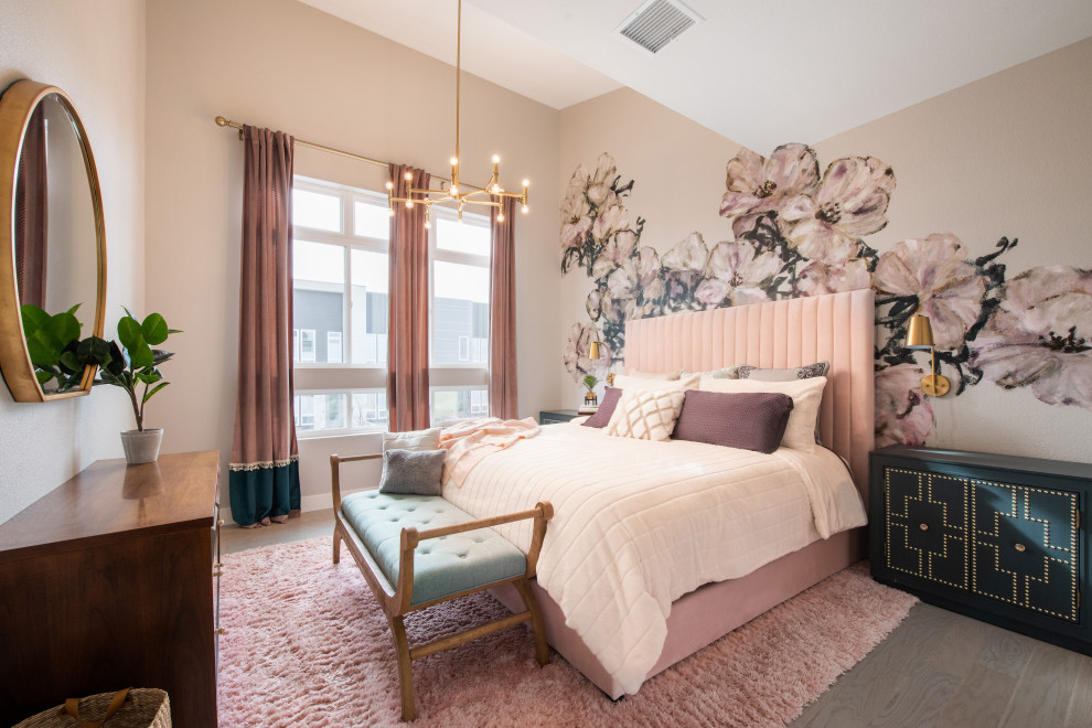 Example of a mid-sized trendy master medium tone wood floor, vaulted ceiling, wallpaper and gray floor bedroom design in Denver with multicolored walls and no fireplace