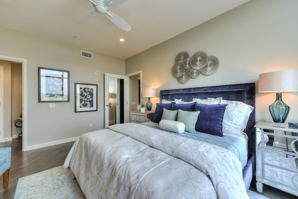 Design ideas for a large traditional master bedroom in Austin with grey walls and medium hardwood flooring.