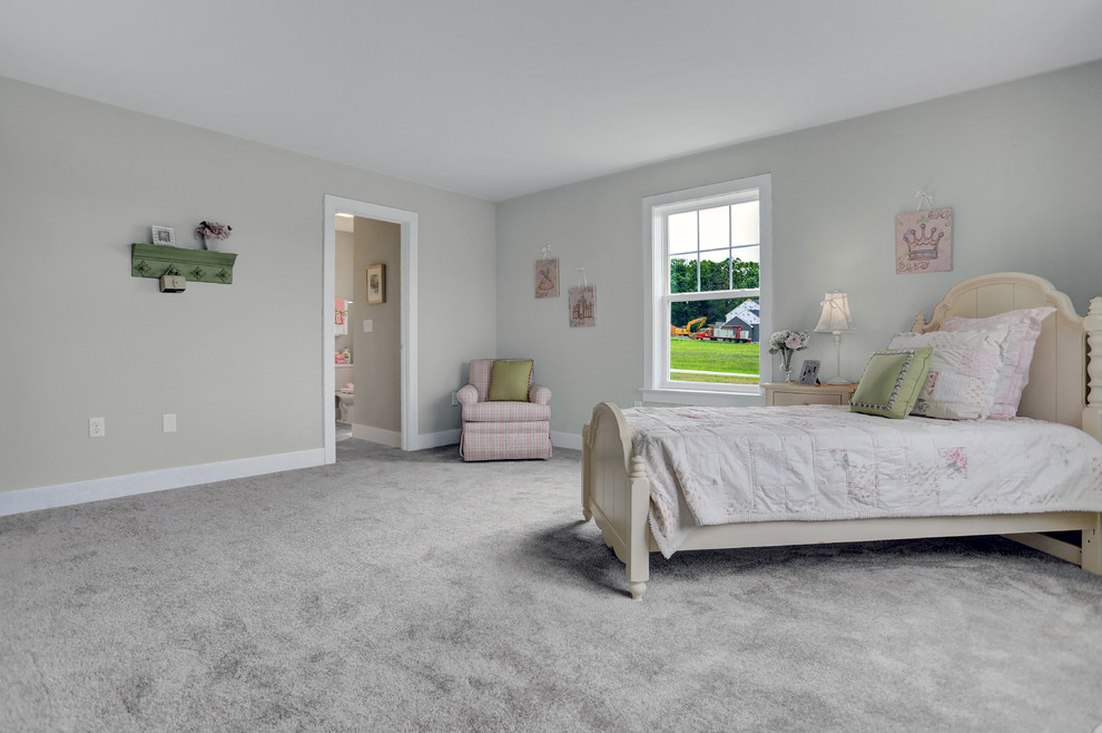 Large classic guest bedroom in Other with beige walls, carpet and beige floors.