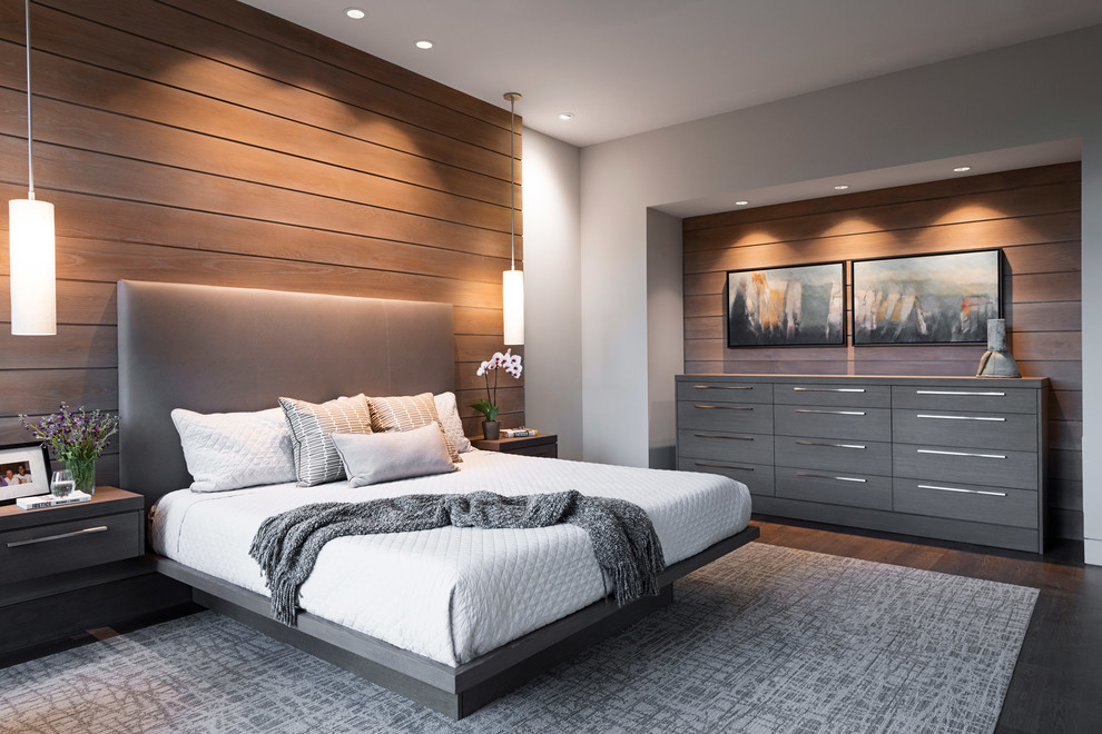 Photo of a large modern master bedroom in Other with beige walls, no fireplace, dark hardwood flooring and brown floors.