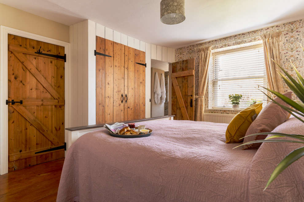 Bedroom - mid-sized transitional master medium tone wood floor, brown floor, shiplap wall and wallpaper bedroom idea in Devon with beige walls