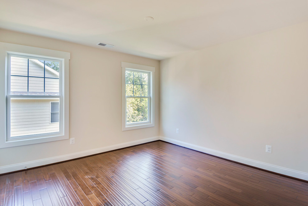 This is an example of a classic bedroom in DC Metro with medium hardwood flooring.