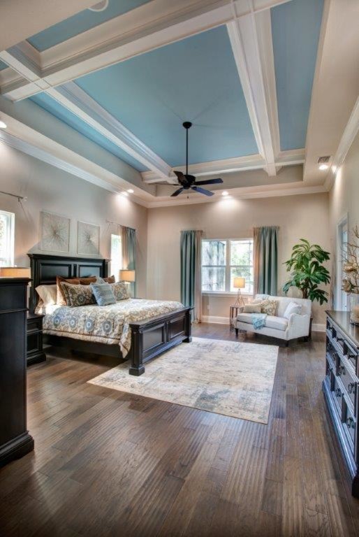 Bedroom - large transitional master medium tone wood floor and brown floor bedroom idea in Orlando with beige walls and no fireplace