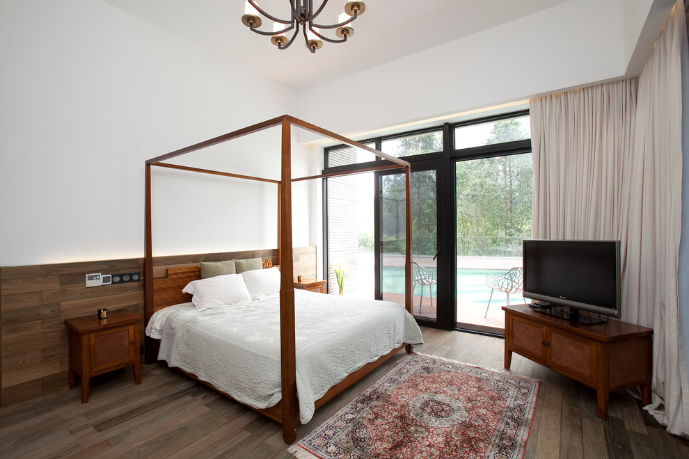 This is an example of a contemporary bedroom in Hong Kong with white walls and medium hardwood flooring.