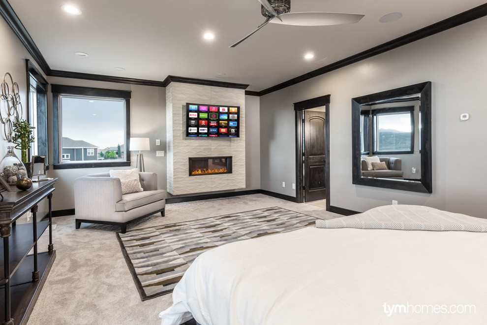 Design ideas for a large traditional master bedroom in Salt Lake City with beige walls, carpet, a ribbon fireplace and a tiled fireplace surround.