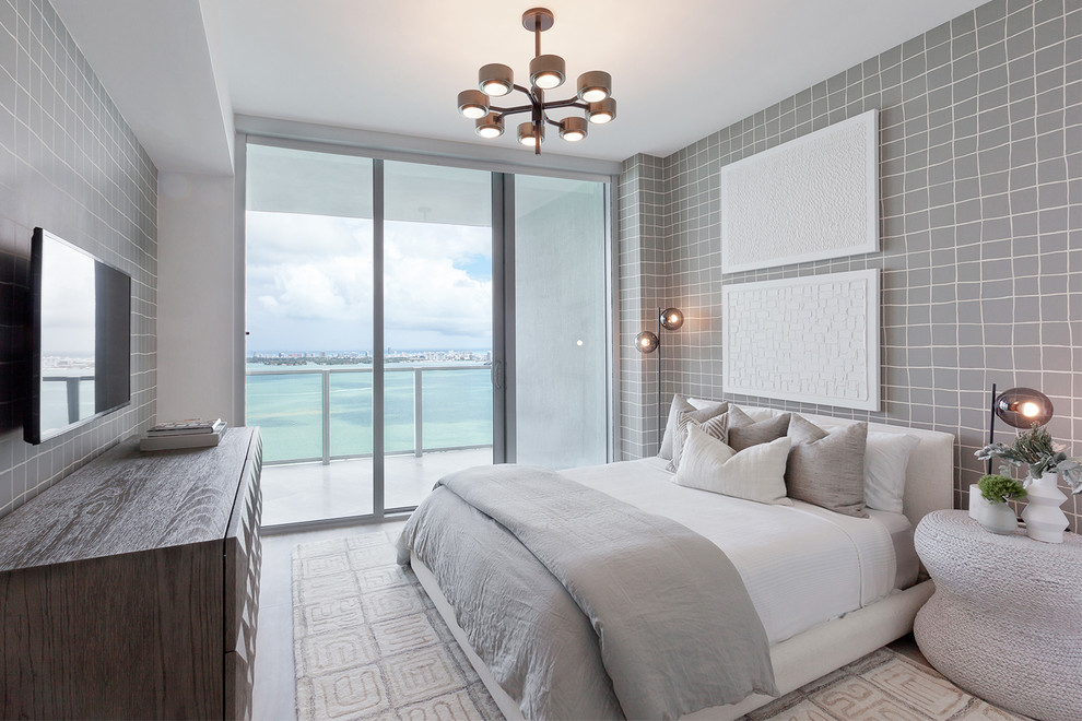This is an example of a contemporary guest bedroom in Miami with grey walls, no fireplace and beige floors.