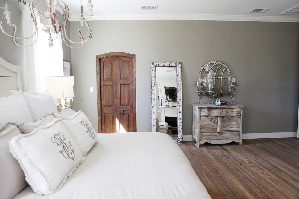Small cottage master medium tone wood floor bedroom photo in Austin with gray walls and no fireplace