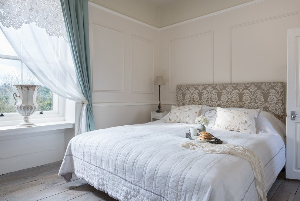 This is an example of a shabby-chic style bedroom in Gloucestershire with pink walls, dark hardwood flooring and brown floors.