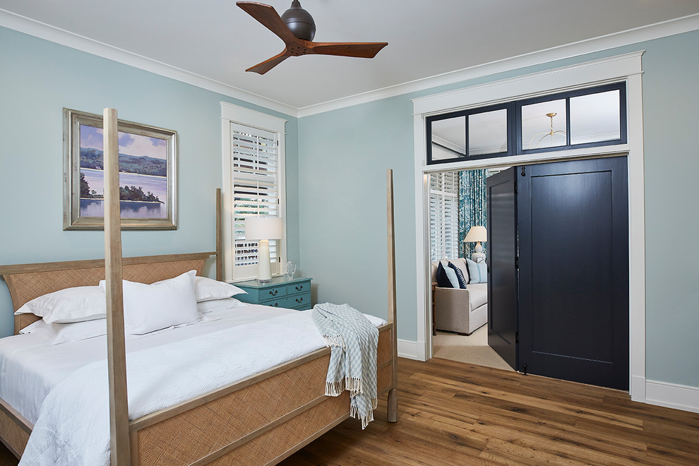 Inspiration for a large transitional master medium tone wood floor and brown floor bedroom remodel in Grand Rapids with blue walls and no fireplace